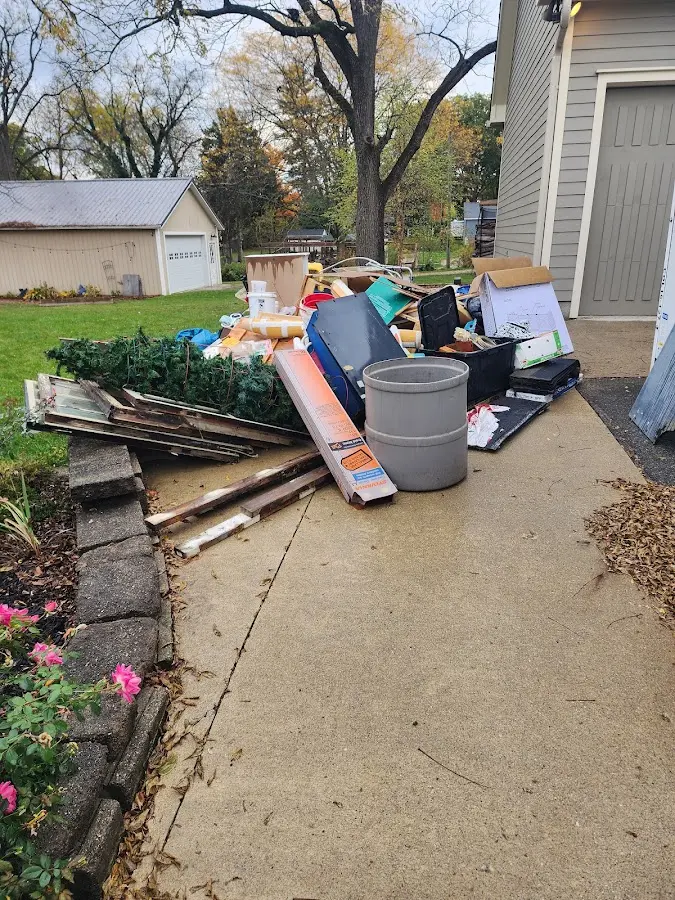 Dumpster being loaded with debris for Estate Cleanout Dumpster Rental in Chapel Hill